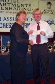 Glenn Cross receiving his prize from Rushen MHK Pam Crowe